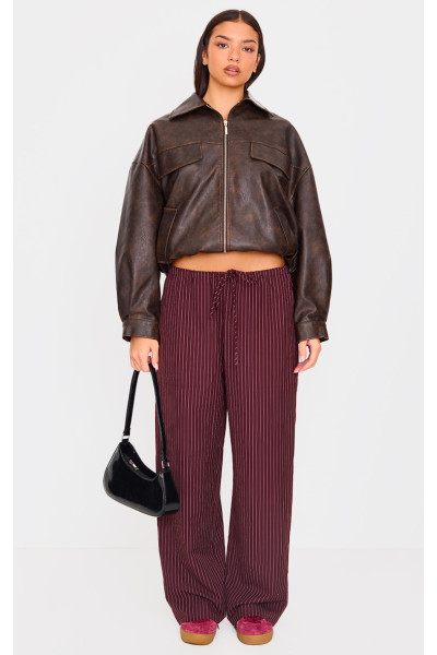 Спокійні брюки бордового кольору з плетеними шнурками та низькою посадкою Спокійні брюки бордового кольору з плетеними шнурками та низькою посадкою